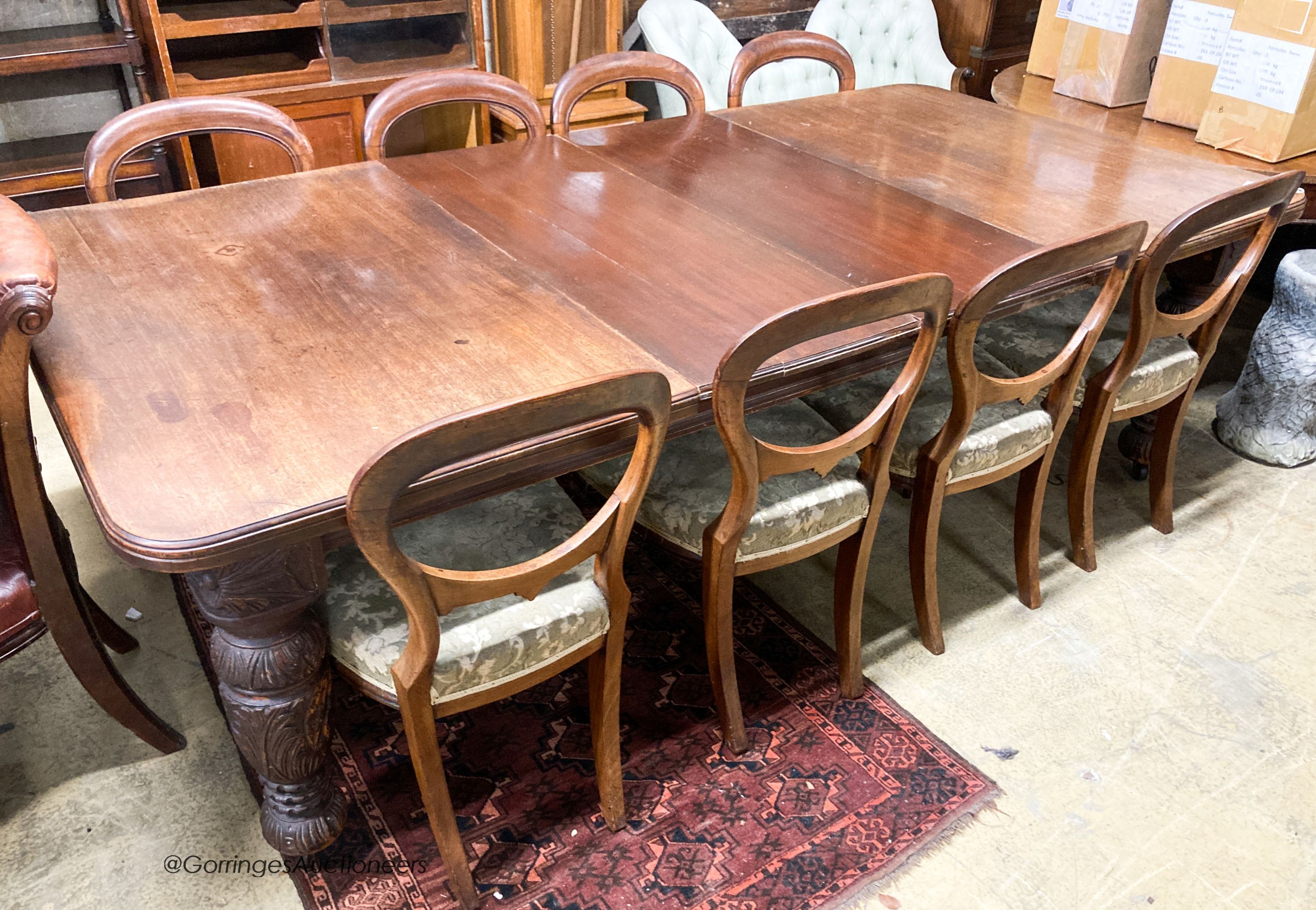 A late Victorian mahogany extending dining table, 238cm extended, two spare leaves, depth 118cm, height 72cm together with a set of eight Victorian mahogany balloon back dining chairs